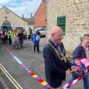 Bridport Mayor Dave Bolwell unravels town's longest scarf from Bridport Community Kitchen