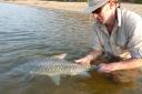 Bournemouth University researcher Adrian Pinder with humpback Mahseer