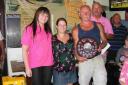 CHAMPION: Tony Denning collects his trophy from Holly Ankers, left, of Weymouth Angling Centre