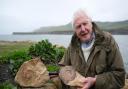 David Attenborough with the ammonite