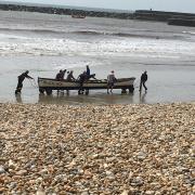 Members of the Lyme Regis Gig Club were able to make their way to shore after their boat capsized Picture: James Burtoft