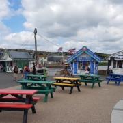 Colourful picnic benches at West Bay