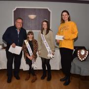 Chairman Graham Davies ably helped by Bridport Royalty Attendants, presenting a cheque to Jodie Glover, on behalf of  Bridport Musical Theatre Company