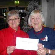 Sandy West from ASDA and Mary Bates for MNDA West Dorset with the cheque for £200