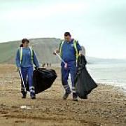DAWN PATROL: On duty at East Beach, West Bay, before the visitors arrive, are resort cleaners Tracey Dear and Adrian Broom.