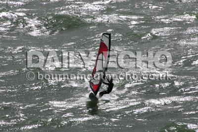 A windsurfer rides over the surf reef at Boscombe.