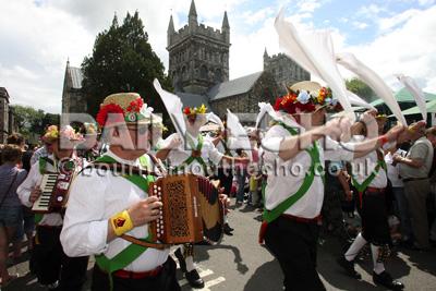 Crowds gather in Wimborne for the annual folk festival as the Morris dance procession makes its way through the town. 