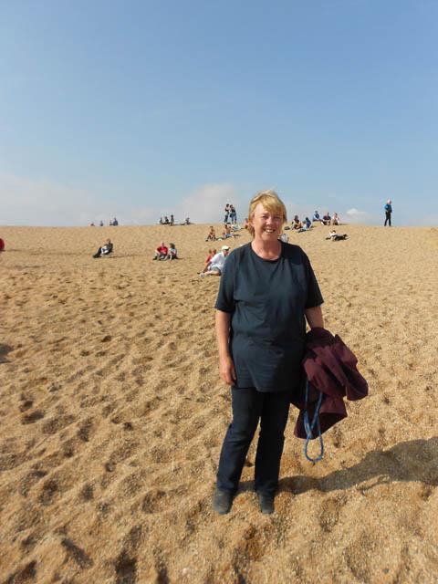 Actress Pauline Quirke takes a break from filming on the beach at West Bay.