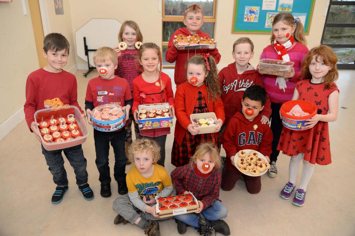 Symondsbury School help a cake sale with pupils dressing in red.