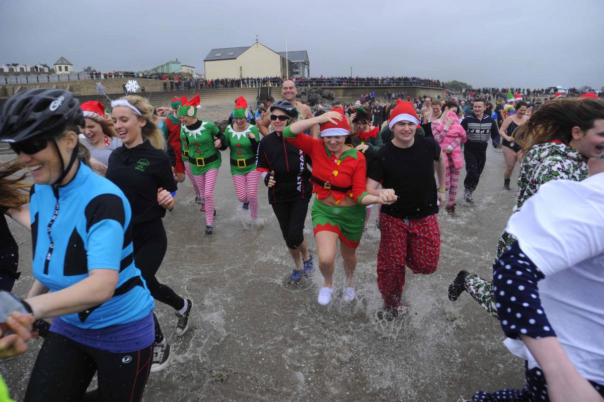 The swimmers run into the sea at the Charmouth Christmas Day Swim 2015 Picture: Graham Hunt Photography