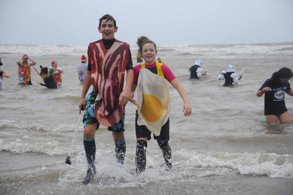 Swimmers coming back out of the sea at the Charmouth Christmas Day Swim 2015 Picture: Graham Hunt Photography