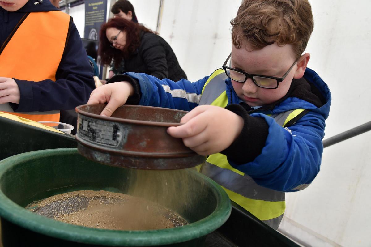 A youngster sieving for teeth at Lyme Regis Fossil Festival. Picture:JOHN GURD JG17646.