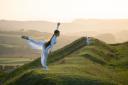 BYD student Lucie dancing in the landscape of Eggardon a hill fort in West Dorset. (Photo: Brendan Buesnel)