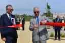 HRH Prince Charles cuts a red ribbon to officially open the new playground at Great Field at Poundbury in Dorchester - 6th May 2022.