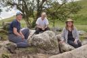 From left to right: Dr Hayley Roberts, Jim Rylatt and Dr Anne Teather of Past Participate CIC with the ‘polishing boulder’, known as a polissoir, recently discovered in Dorset.