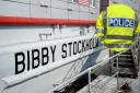 Police and Bibby Stockholm barge