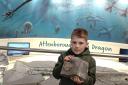 Myles, the 100,000th visitor to the Charmouth Heritage Coast Centre