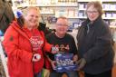 Pots of cash - Debbie Claridge (left), Julian Coles and Lyme Regis RNLI shop volunteer Lorraine Vandersyde