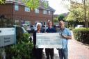 From left, Glenda Froud, Gary Smith and Malcolm Andrews with a cheque for Forest Holme Hospice in Poole.