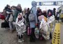 Refugees stand in a group after fleeing the war from neighbouring Ukraine at the border crossing in Palanca, Moldova, Thursday, March 10, 2022. (AP Photo/Sergei Grits)Refugees stand in a group after fleeing the war from neighbouring Ukraine at the border