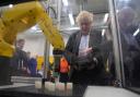 Prime Minister Boris Johnson using a robotic machine during a campaign visit to Burnley College Sixth Form Centre  in Burnley, Lancashire. Picture date: Thursday April 28, 2022. PA Photo. See PA story POLITICS Johnson . Photo credit should read: Peter
