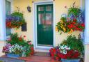 A front porch with hanging baskets and colourful planters Picture: Alamy/PA