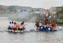 Competitors in fancy dress compete in the annual RNLI Raft Race on the River Brit at West Bay. Teams having a water fight before the start of the race - 21st July 2022.  Picture Credit: Graham Hunt Photography