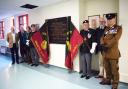Past and present members of the Dorset Regiment with the refurbished plaque at Dorset County Hospital