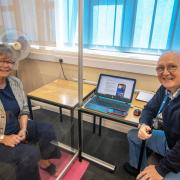 Resident Dawn Devenish receives advice from volunteer digital champion Ian Hudson, at Ferndown Library Picture: Dorset Council