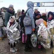 Refugees stand in a group after fleeing the war from neighbouring Ukraine at the border crossing in Palanca, Moldova, Thursday, March 10, 2022. (AP Photo/Sergei Grits)Refugees stand in a group after fleeing the war from neighbouring Ukraine at the border