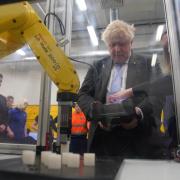 Prime Minister Boris Johnson using a robotic machine during a campaign visit to Burnley College Sixth Form Centre  in Burnley, Lancashire. Picture date: Thursday April 28, 2022. PA Photo. See PA story POLITICS Johnson . Photo credit should read: Peter