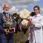 Trophy presentation in 2022 - Former Mayor Ian Bark presented the Townspeople of Bridport Challenge Cup for Best Beef Beast to Vexour 1 Phantom owned by the Mitchell family during the Grand Parade at the Melplash Show