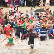 Hundreds of New Years Day revellers in fancy dress, watched by huge crowds, take part in the annual Lyme Lunge charity swim at Lyme Regis in Dorset.  1st January 2023.  Picture Credit: Graham Hunt