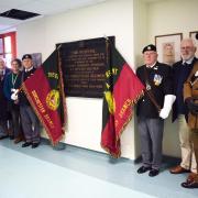 Past and present members of the Dorset Regiment with the refurbished plaque at Dorset County Hospital