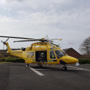 Dorset and Somerset Air Ambulance helicopter on the helipad at Dorset County Hospital
