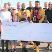 Lifeboat crew with two of the four family walkers, second and third from left, Rachael Tattershall mother of Catherine Crabbe. Also pictured Catherine's children William,9, and Charlie, 6.