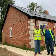 Rowland Hibbard, Broadwindsor Group Parish Community Land Trust chairman and Sheila Hawkins BGPCLT secretary outside one of the Drimpton homes and a photo of the entry to the site.