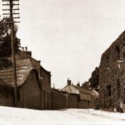 The junction of the Axminster Road, Street, Old Lyme Hill and Old Lyme Road. The sign is informing people not to use the coastal road as in 1926 it disappeared after a Landslip between Charmouth and Lyme Regis. The pretty thatched building house was to