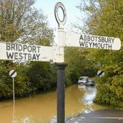 A flood alert is in place for west Dorset rivers. Pictured, the River Bride burst its banks in October 2023