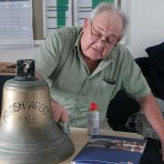 The bell at Lyme Regis lifeboat station being polished ahead of Fred's birthday visit