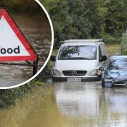 A car and a van abandoned in floodwater after they became stuck on Bredy Lane at Burton Bradstock after heavy overnight rain