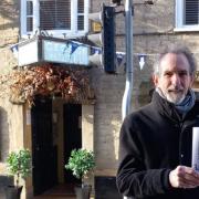 Booklet author Tegwyn Jones standing outside Bridport pub the George Hotel