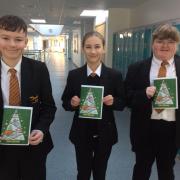 William, 11, Freya, 11 and Daisy, 11 of Sir John Colfox School with the Christmas card for Street Vet