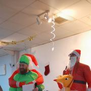 The quizmasters dressed in inflatable Christmas outfits