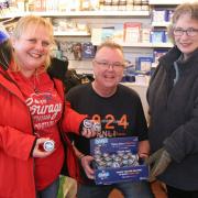 Pots of cash - Debbie Claridge (left), Julian Coles and Lyme Regis RNLI shop volunteer Lorraine Vandersyde