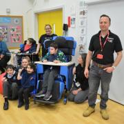 Rob from R N Stephenson Electrical Contractors photographed with some of the students benefitting from his generosity.