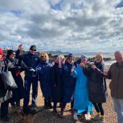 Campaigners on Church Beach celebrating the news that the beach could be safe for bathing