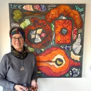 Lyme Regis artist Christine Allison with one of her paintings for her Treasures exhibition at the Rotunda Gallery of the Lyme Regis Museum.