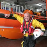 At the lifeboat helm, paramedic Mark Ellis alongside the Spirit of Loch Fyne
