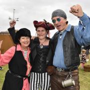 Sandy Malpas, Helen Goldman and Kevan Manwaring in costume at Pirate Day at West Bay, 2022